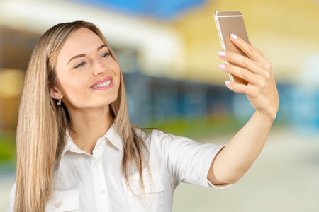 Happy young woman taking selfieの写真素材