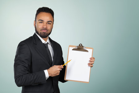 Portrait of a handsome black man businessman holding a clipboard