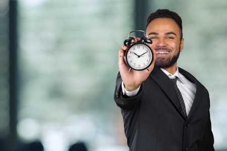 Black businessman with alarm clock. Time management conceptの写真素材