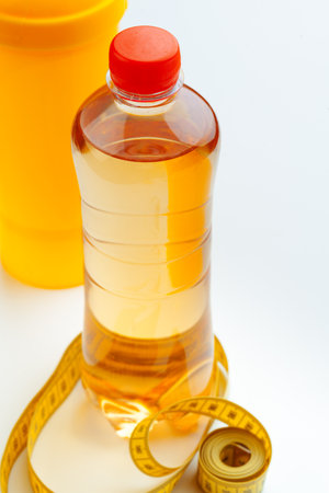 Bottled water for healthy life and measuring tape over a white backgroundの写真素材