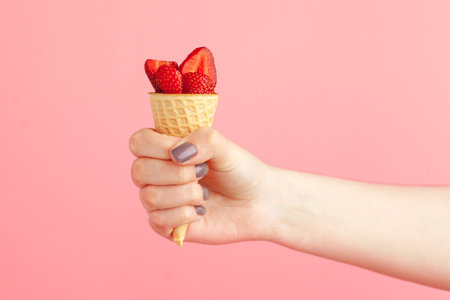 Fresh strawberry in waffle cone. Creative food conceptの写真素材