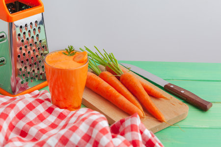 Glasses of carrot juice with vegetables on table close upの写真素材