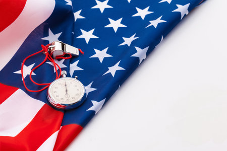 Metal Sport Whistle And Stopwatch On American Flagの写真素材