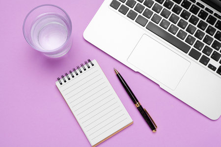 bottle of water on office table near laptopの写真素材