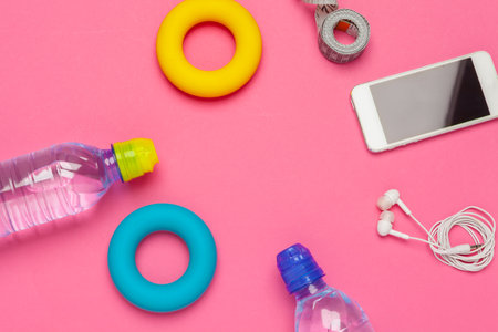 fitness concept with bottle of water, mobile phone with earphonesの写真素材