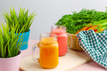 Carrot smoothie with parsley on a tableの写真素材