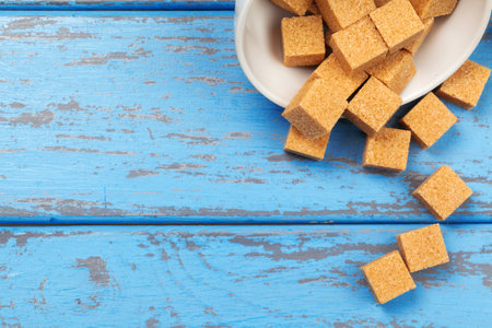 Brown cane sugar cubes isolated on white backgroundの写真素材