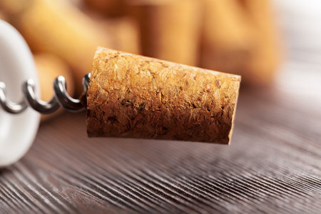 Wine corks with corkscrew on wooden tableの写真素材