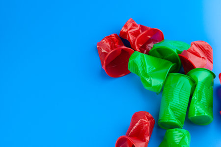 Crumpled empty single-use plastic cups, studio shot. Plastic pollution conceptの写真素材