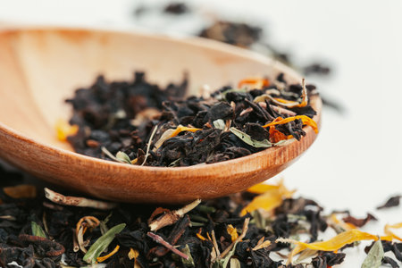 Dried tea heaped teaspoonful on white background, closeupの写真素材