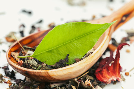 Dried tea heaped teaspoonful on white background, closeupの写真素材