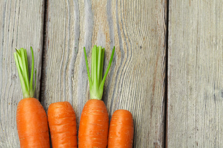 Close up of fresh carrot on rustic wooden backgroundの写真素材