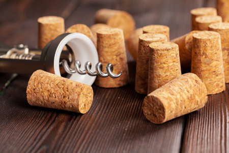 Wine corks with corkscrew on wooden tableの写真素材