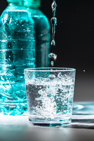 Served table set of mineral water bottle and glass