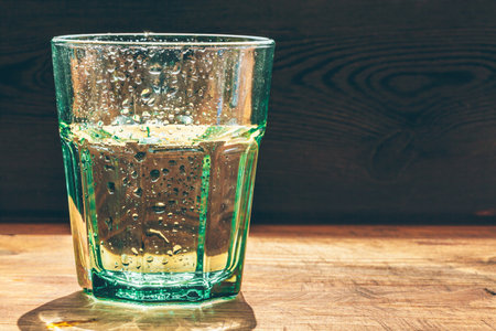 Glass of water on dark background close upの写真素材