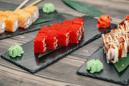 Sushi served on a slate plate in a restaurantの写真素材