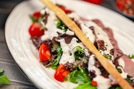 bread sticks with a salad of veggies and sauceの写真素材