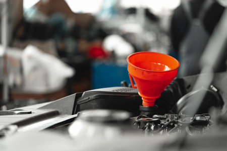 Close up of orange funnel for oil change in car engineの写真素材