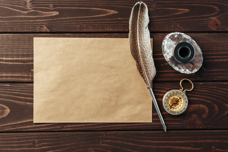 Top view of an old paper on brown wooden texture background with feather