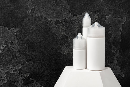 Electronic cigarette vape liquids on black backgroundの写真素材