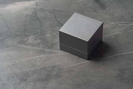 Small jewelry box on gray background close up
