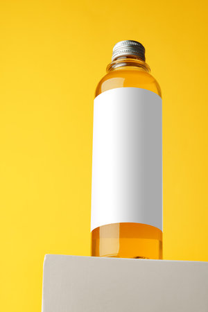 Bottle with skincare oil against yellow backgroundの写真素材