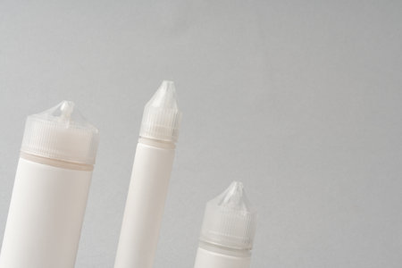 Refill liquid for electronic cigarettes on gray backgroundの写真素材