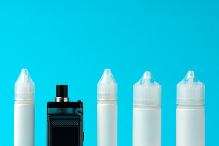 Electronic cigarettes liquid bottles on blue backgroundの写真素材