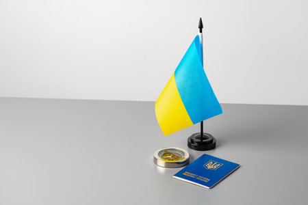 Ukrainian flag, Ukrainian passport and compass on gray tableの写真素材