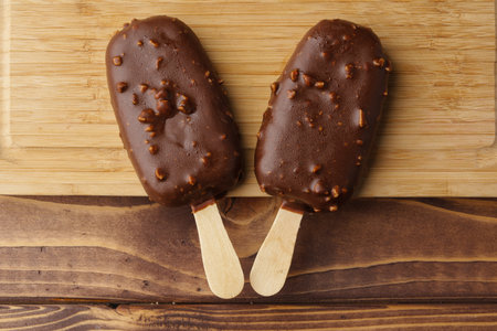 Chocolate cake pops ice creams on wooden board close upの写真素材