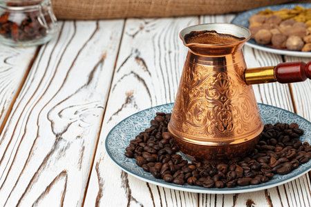 Coffee in copper turk on coffee beansの写真素材
