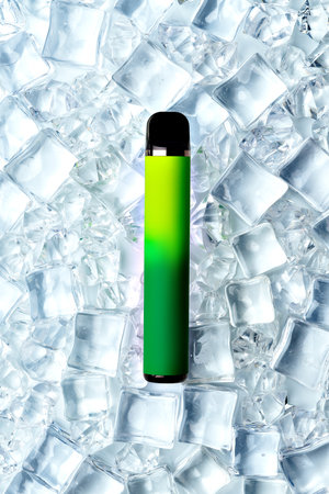 Disposable electronic cigarette on ice cubes backgroundの写真素材