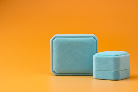 Blue jewelry box on yellow background close up