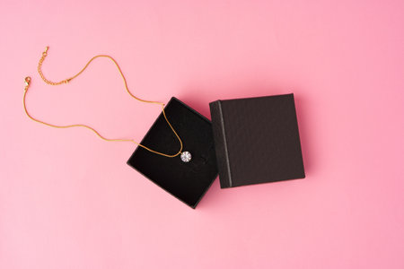 Small jewelry box on pink studio background