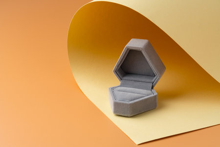 White jewelry box on yellow studio backgroundの写真素材