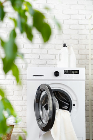Detergent bottle on washing machine in a laundry roomの写真素材