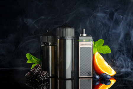 Vape and smoking liquid with fruit against black background with smoke