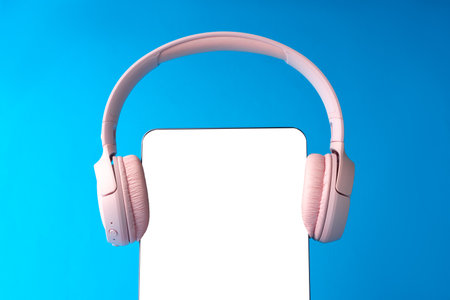 Headphones on digital tablet on blue backgroundの写真素材