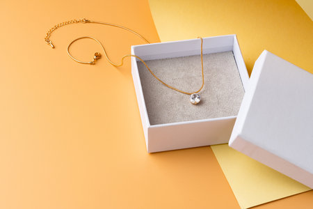White jewelry box on yellow studio backgroundの写真素材