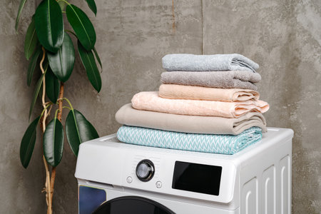 Stacked towels on washing machine in laundry room