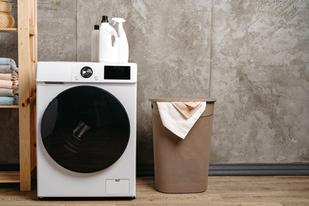 Washing machine in a gray modern laundry roomの写真素材