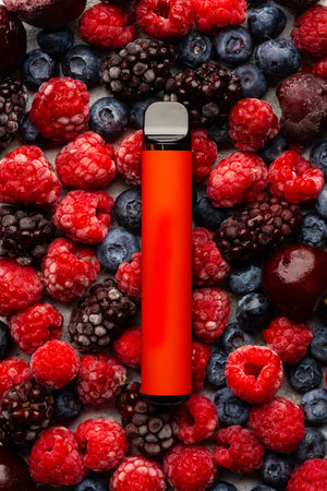 Electronic cigarette on frozen berries top viewの写真素材
