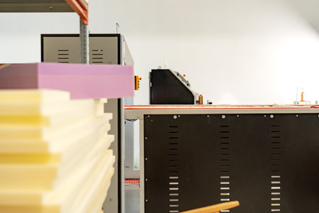 Stacked sheets of foam rubber for furniture production in factory workshop