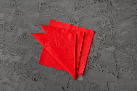 Stack of paper square napkins on gray backgroundの写真素材