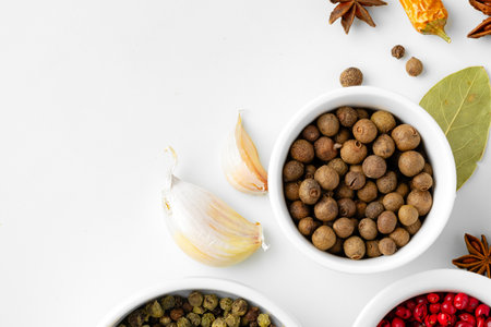 Various spices in a bowls on white background