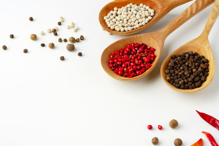 Wooden spoons with various spices isolated on white backgroundの写真素材