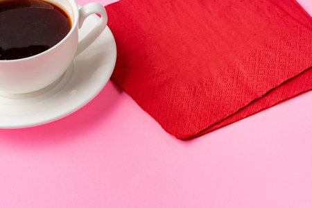Coffee cup with paper napkins on pink backgroundの写真素材