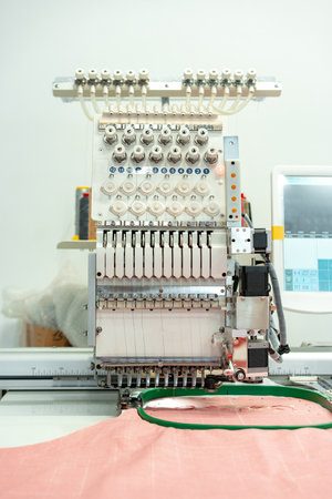 Close up of embroidery machine making patterns on textiles