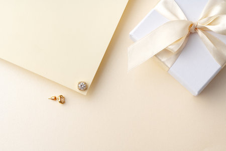 Golden earrings on paper background studio shotの写真素材