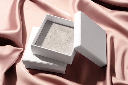Empty jewelry box on silk background close upの写真素材